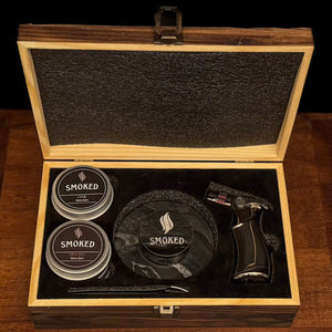 Wooden box with smoked product packaging on a wooden surface